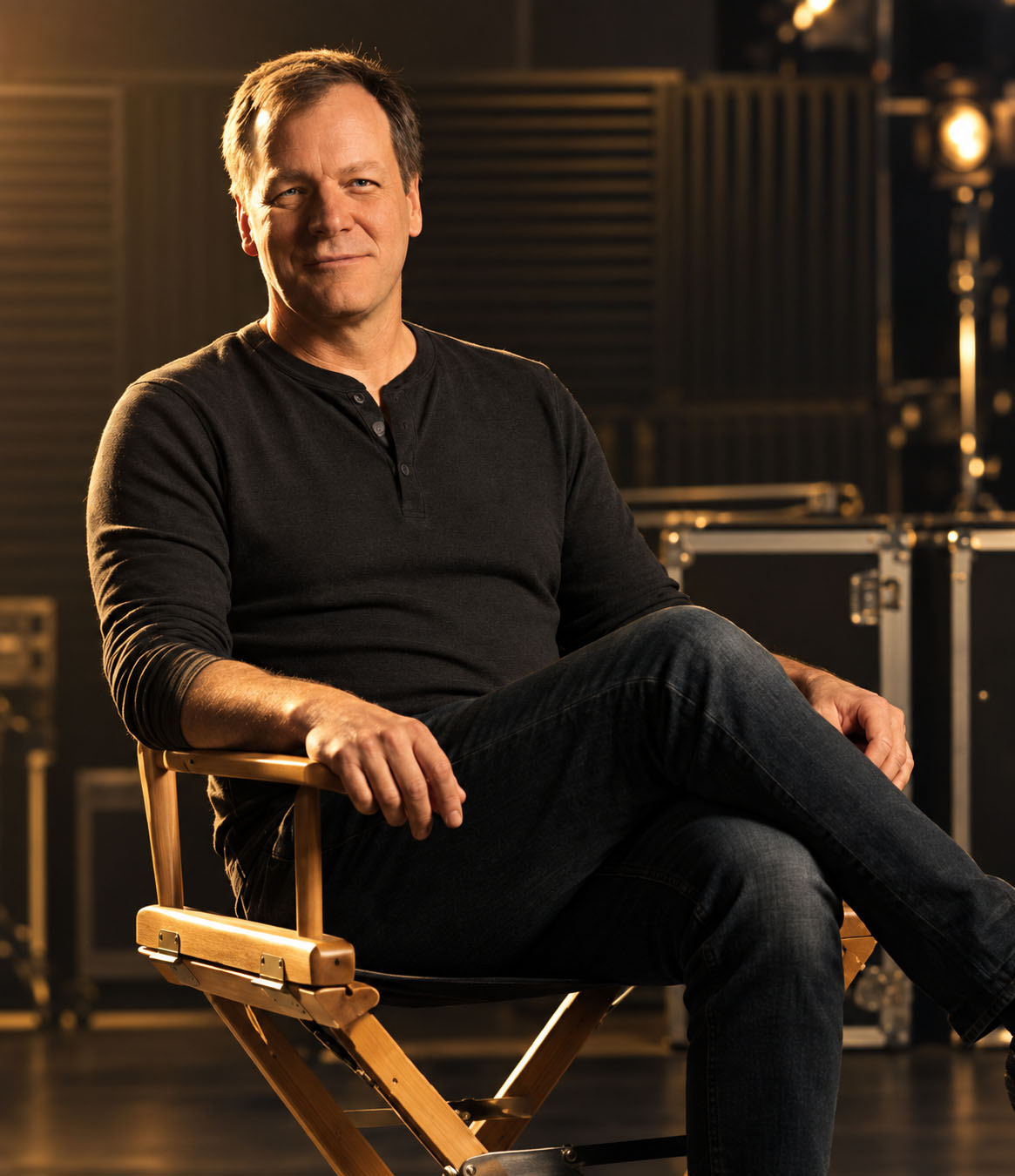 Dan Hellman seated in a director's chair in the studio.